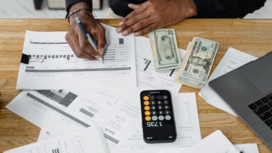A government contract controller reviewing indirect rate schedules and job cost reports, the kind of DCAA-compliant accounting talent Spectrum Careers places with GovCon employers