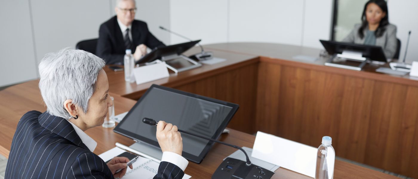 Investment firm executives reviewing financial reporting in a boardroom