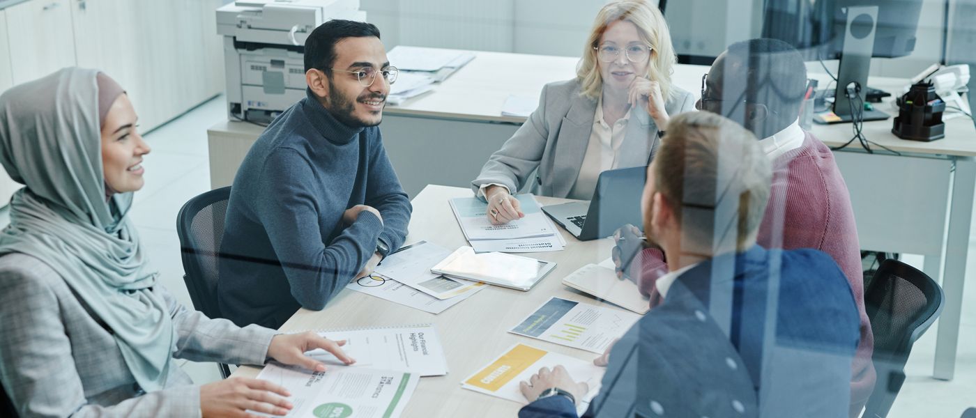 A government contracting finance team reviewing contract performance together at a conference table