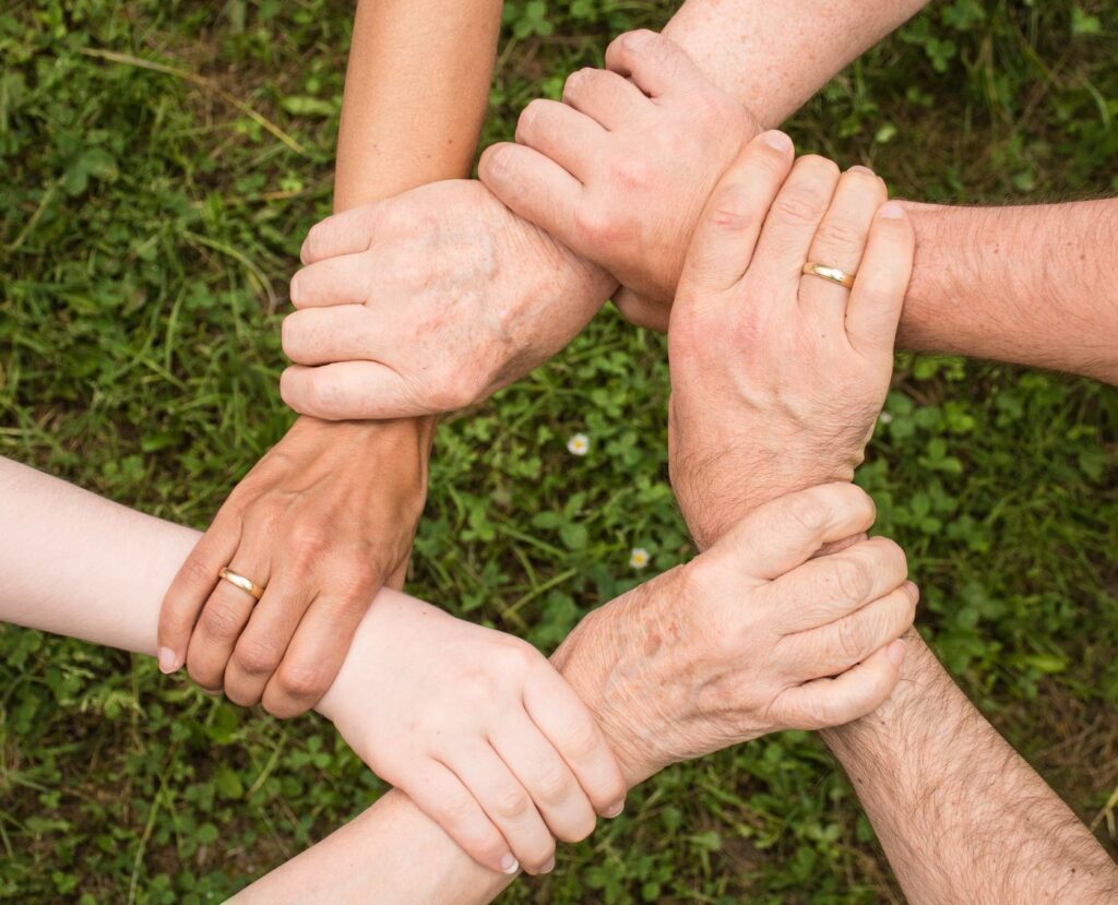inline nonprofit hands unity 461049 Diverse hands linked in a circle, representing the non-profit community Spectrum Careers serves